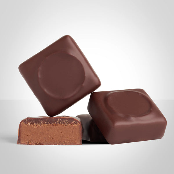 Bonbons praliné noisette en chocolat au lait de L'Instant Cacao et bonbon coupé en deux